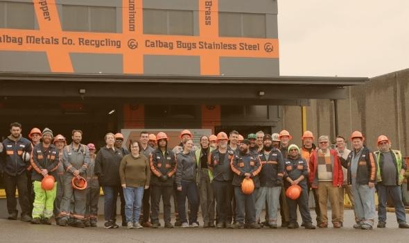 Employees of Calbag Metals standing in a line for Team Photo