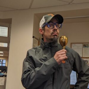 Eli Lane holding a brass cup